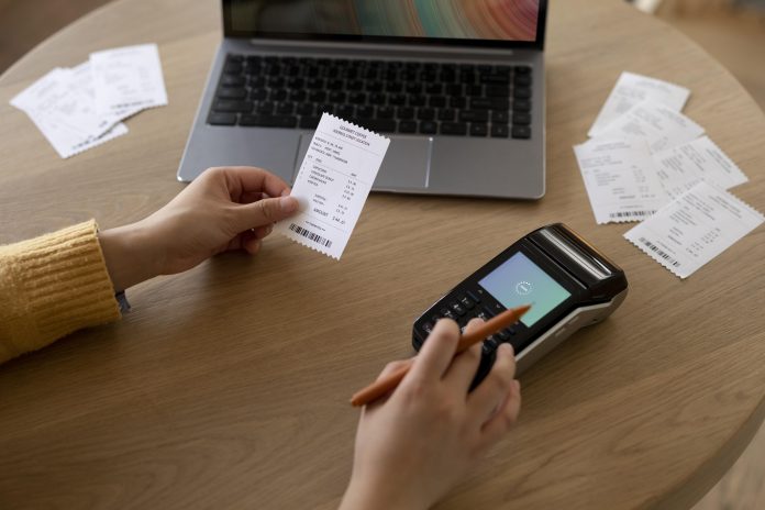 close-up-hand-holding-receipt