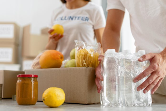 low-angle-volunteers-preparing-food-donation