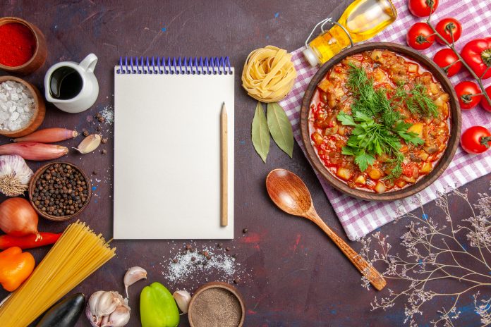 top-view-tasty-cooked-vegetables-sauce-meal-with-tomatoes-seasonings-dark-background-sauce-meal-dish-food