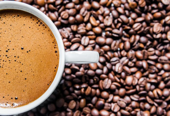 Coffee cup and coffee beans on table, top view, love coffee, Bro