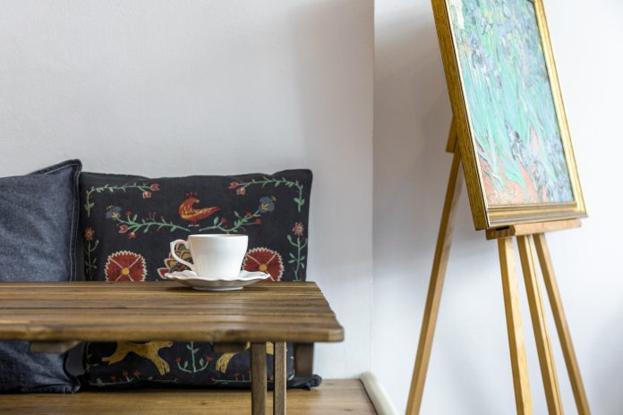 coffee-cup-saucer-wooden-table-front-cushion-easel