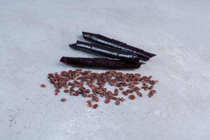 Raisins and sour cherry plum snacks on marble background