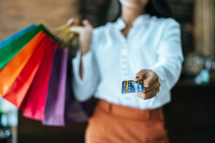 Young women enjoy shopping with credit cards.