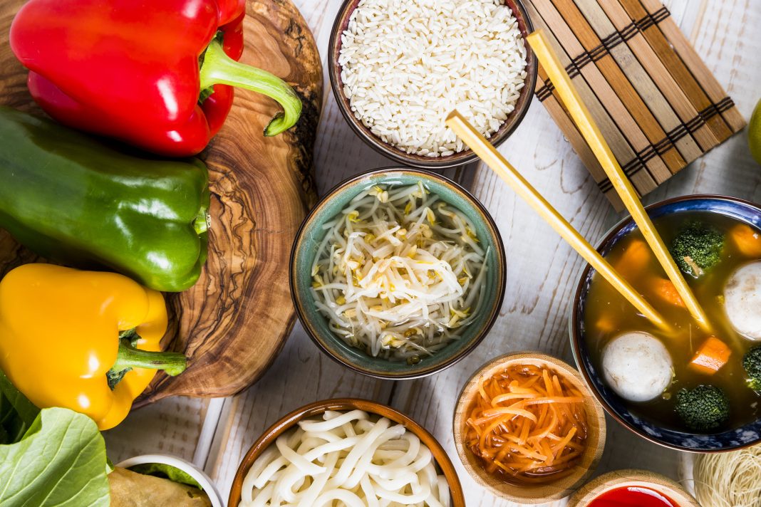 flat-lay-thai-delicious-food-with-colorful-bell-peppers-tree-stump