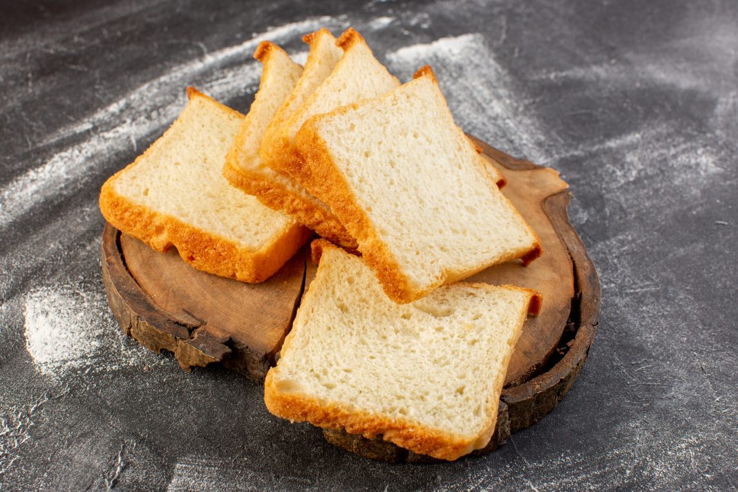 front-view-white-bread-loafs-sliced-wooden-desk